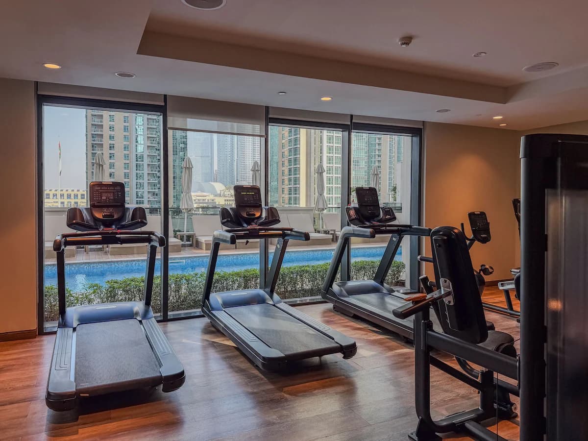 Residents’ gym with treadmills and weights at Act One / Act Two
